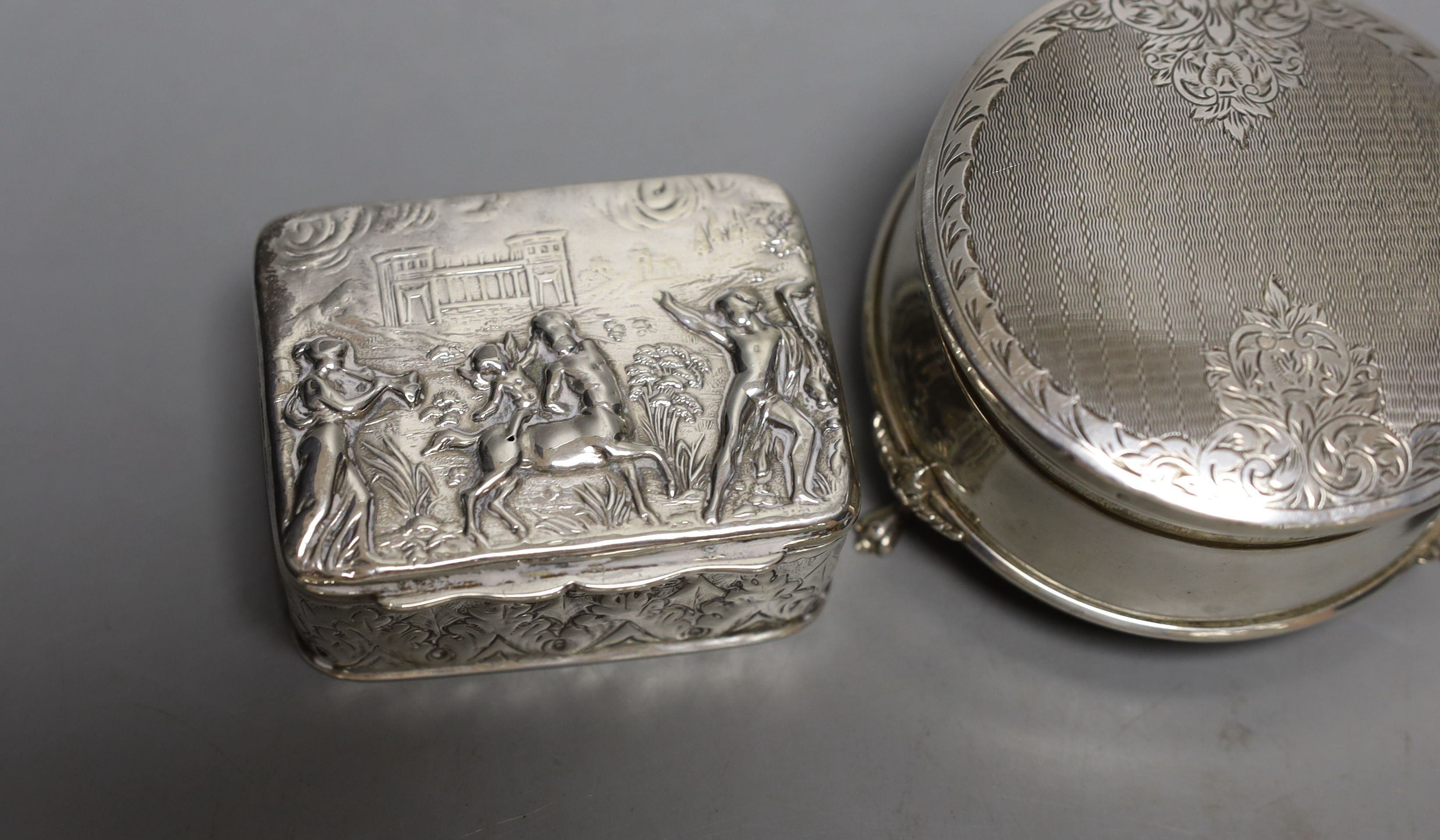 A modern silver mounted trinket box,82mm and two late Victorian embossed silver small boxes.